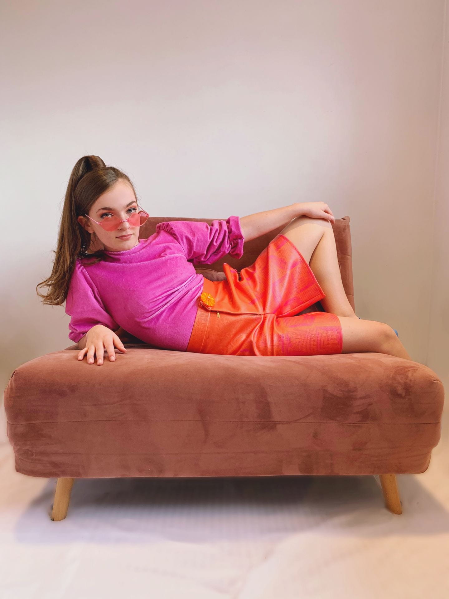Photograph of a girl sat on a chair modelling an item in the 'Let's Get Trippy' collection.