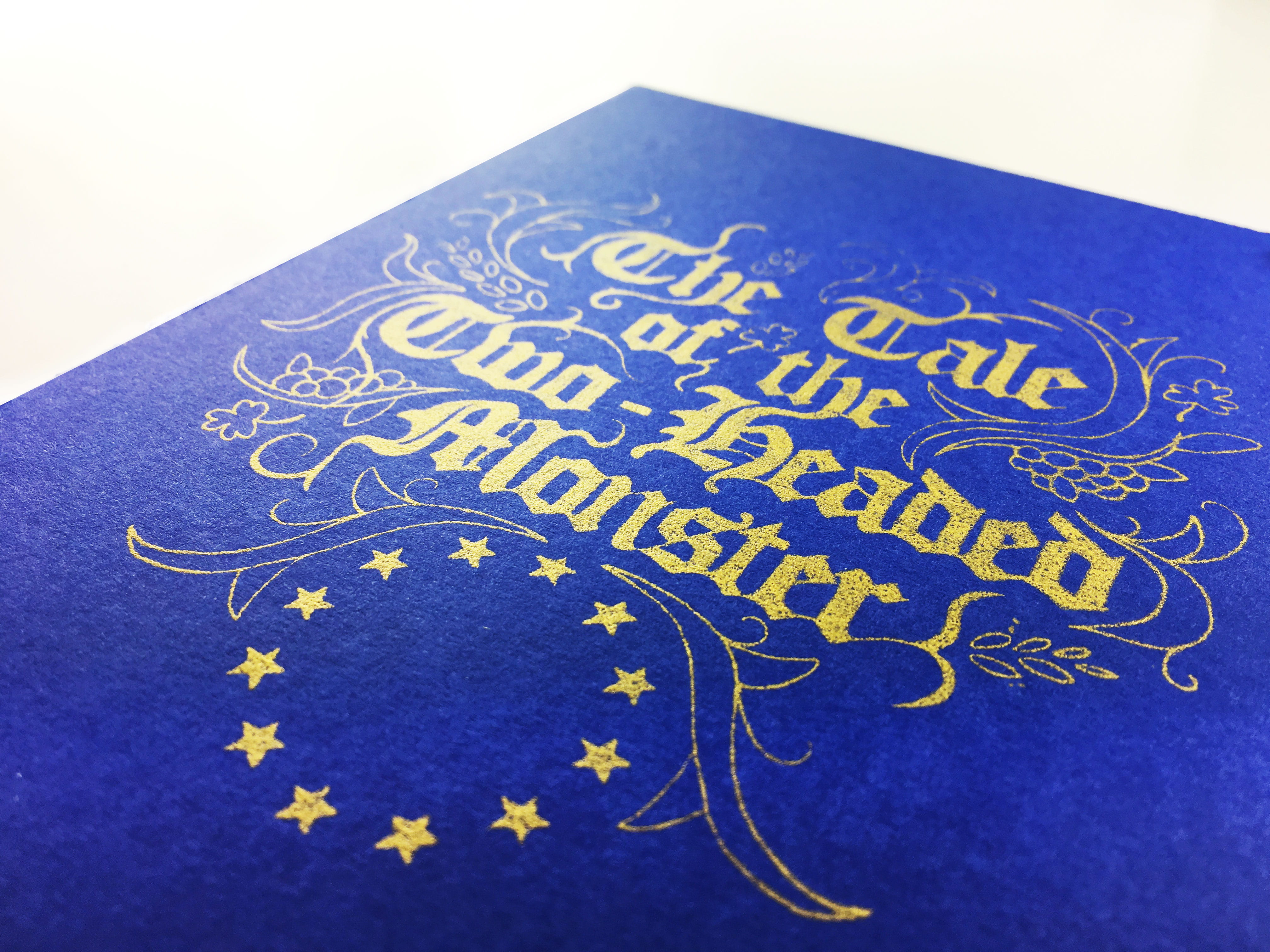 A deep-blue box, with the flag of the European Union under calligraphy text reading: 'The Tale of the Two Headed Monster.'