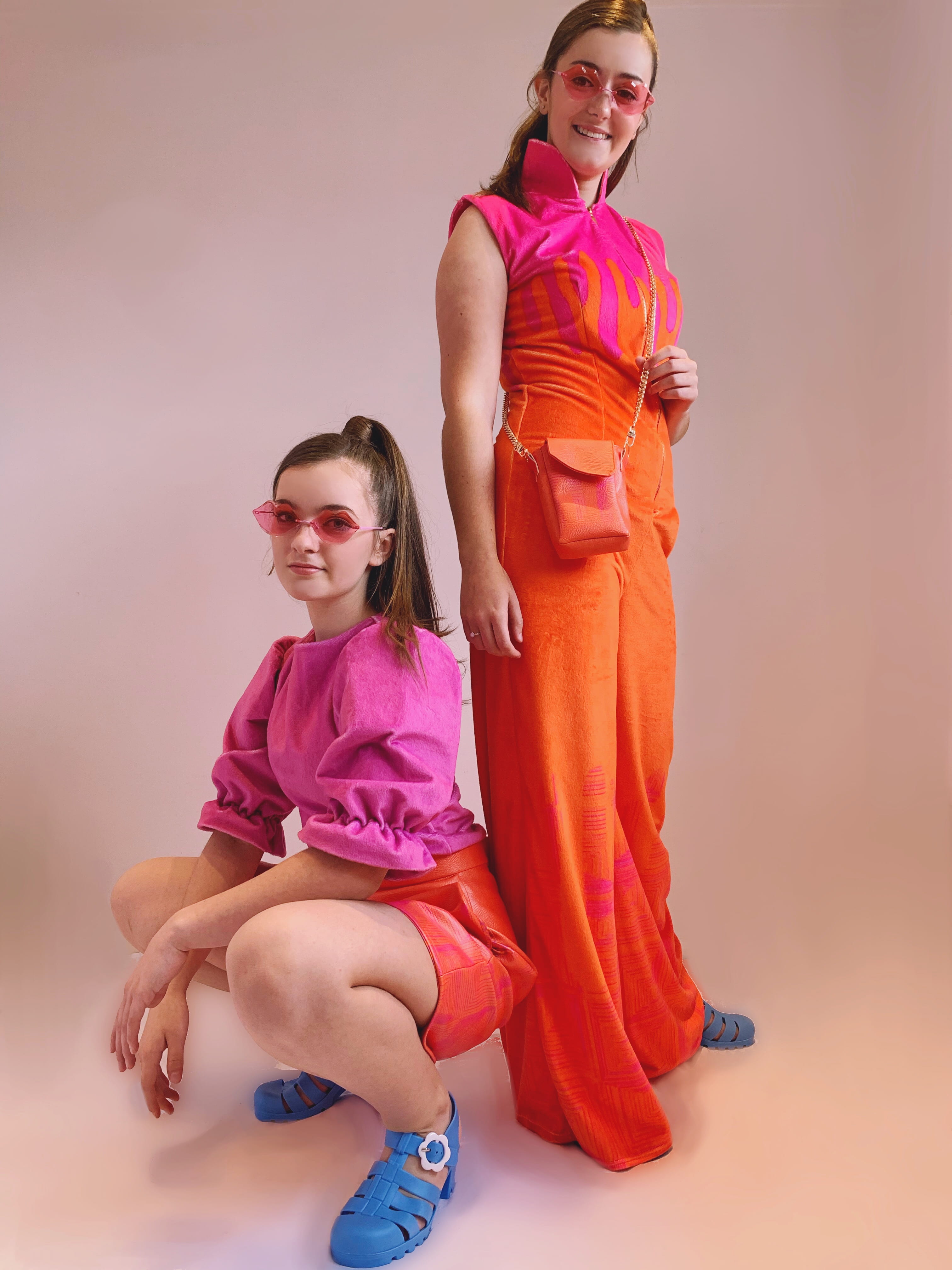 Photograph of two girls (one standing, one crouching) modelling an item in the 'Let's Get Trippy' collection.