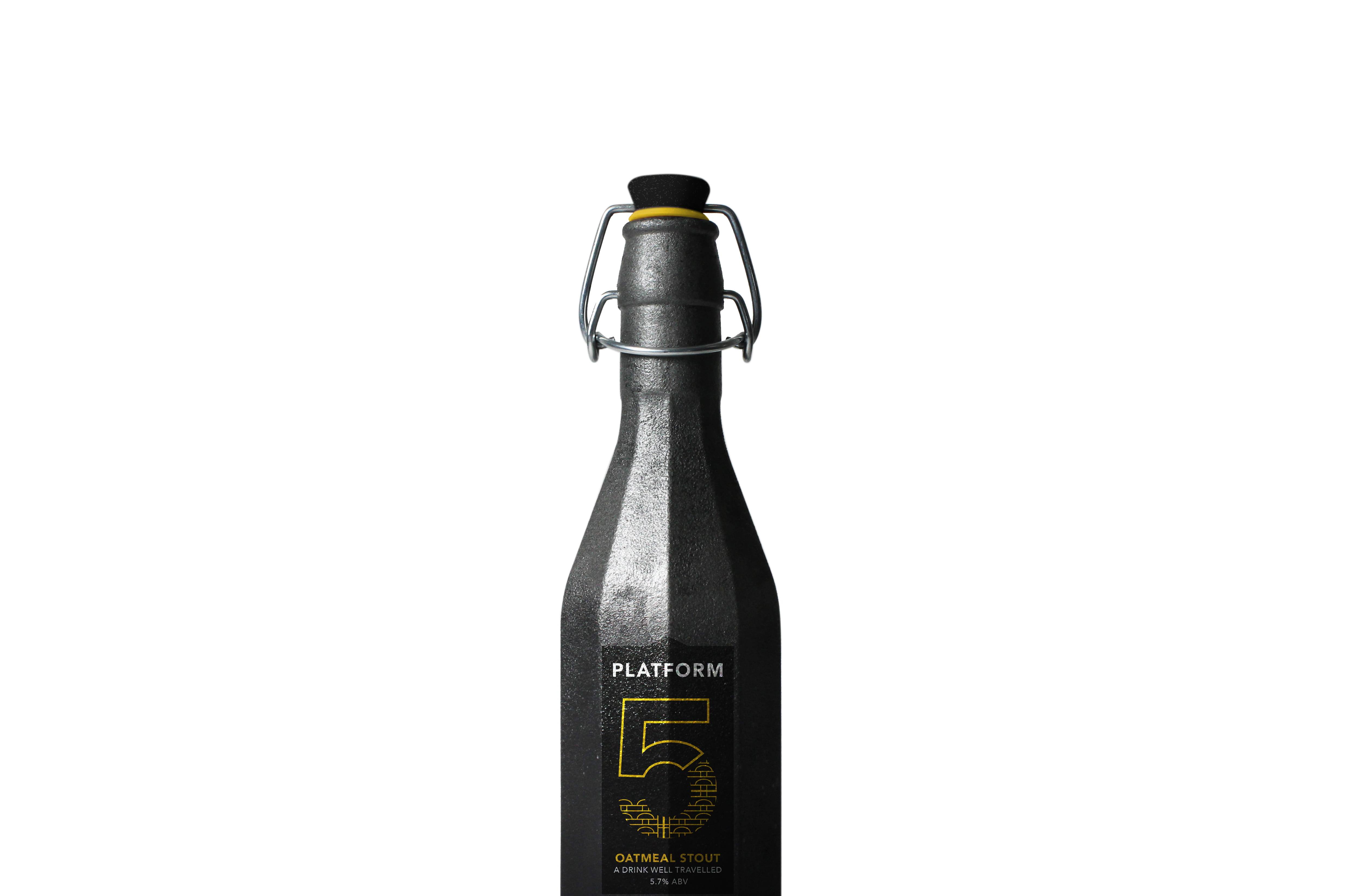 A dark pewter bottle with a black label, reading: 'Platform 5'.
