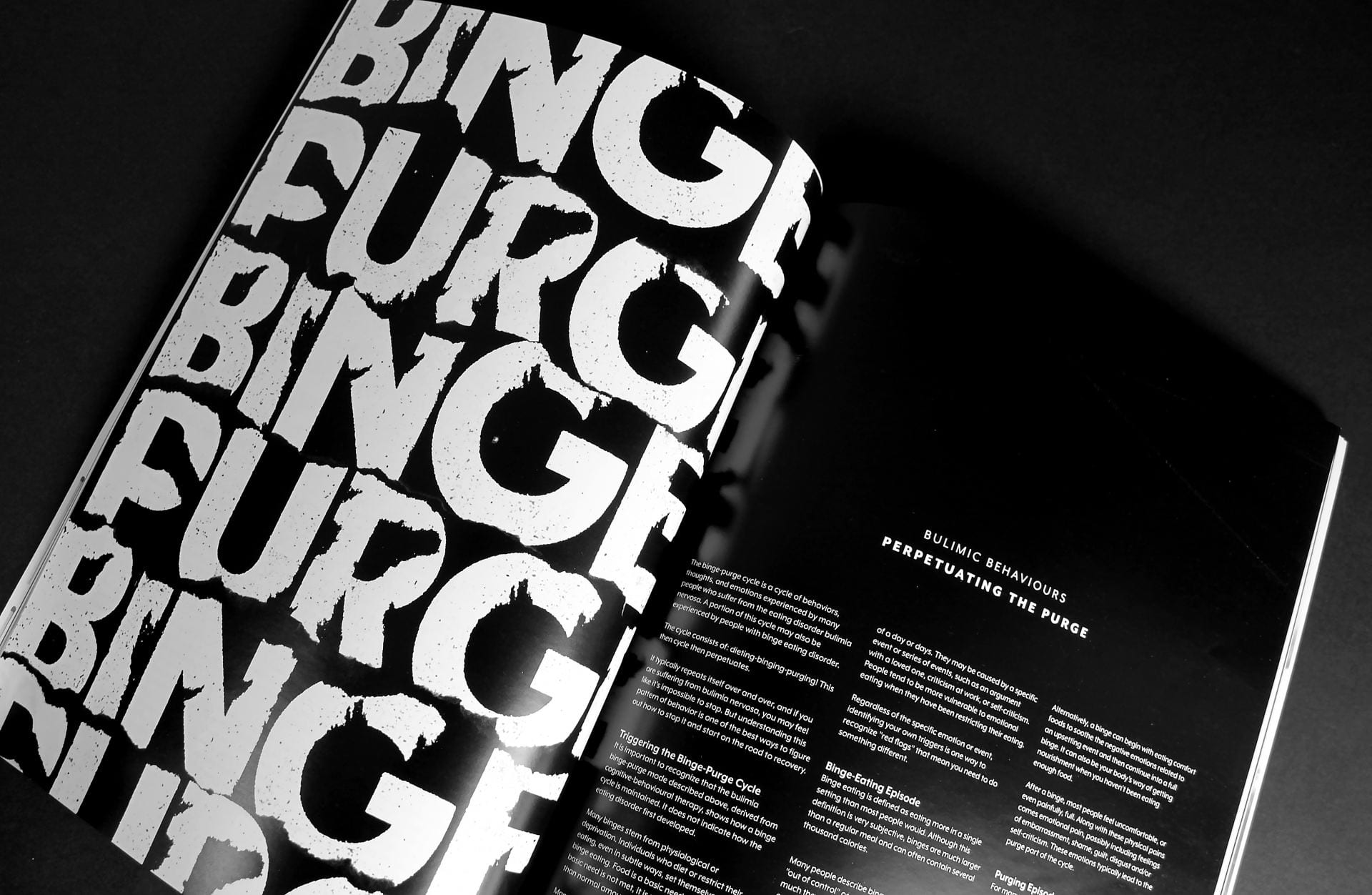 Pages of a black and white magazine with the left page reading: 'Binge, Purge,' in large, white text.