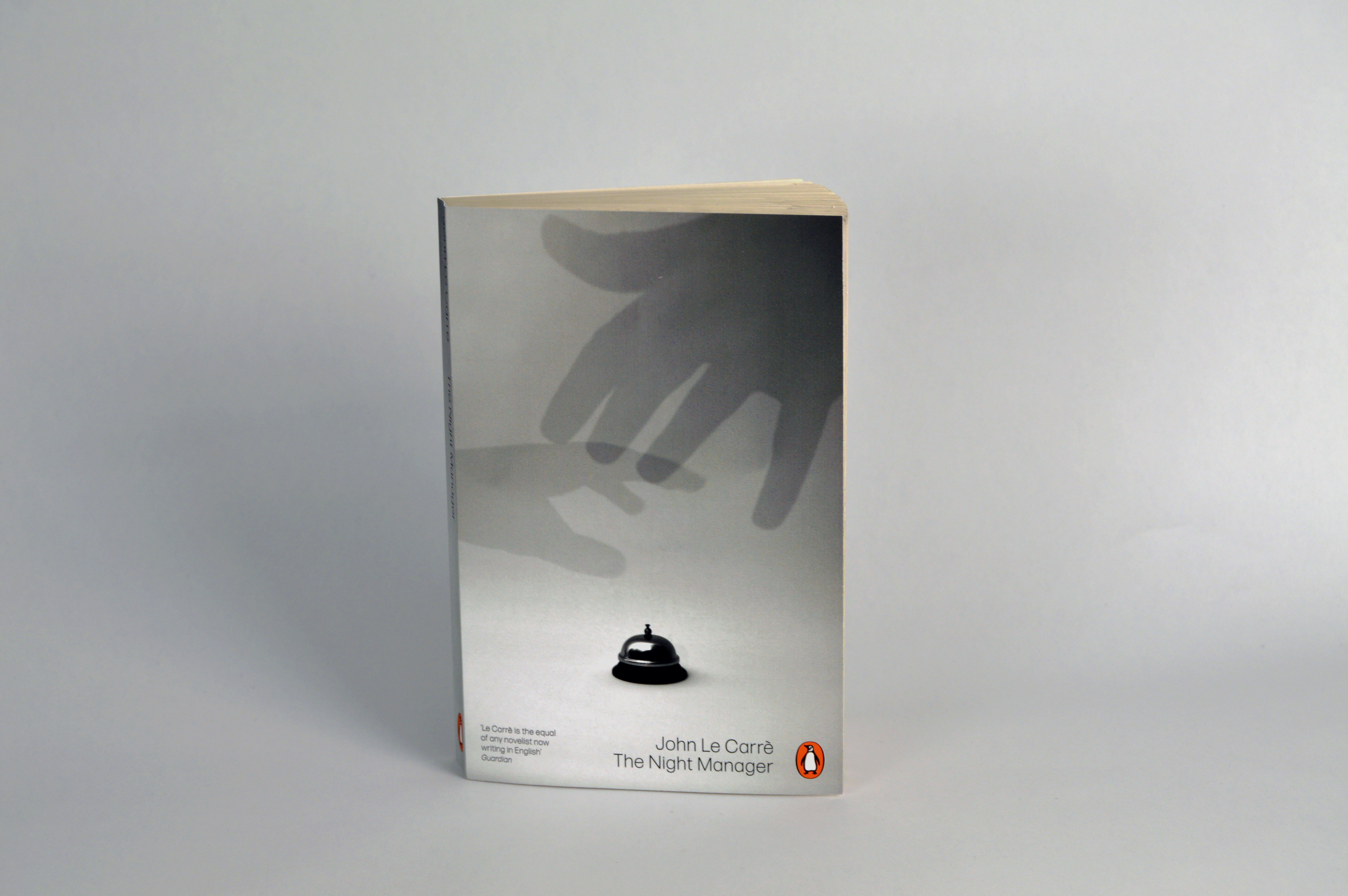 Front view of cover design depicting the artwork of 2 hands reaching for the receptionists bell.