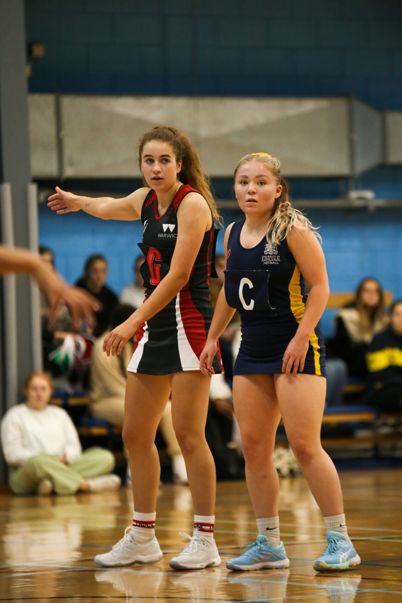 Two netball players during a netball match.