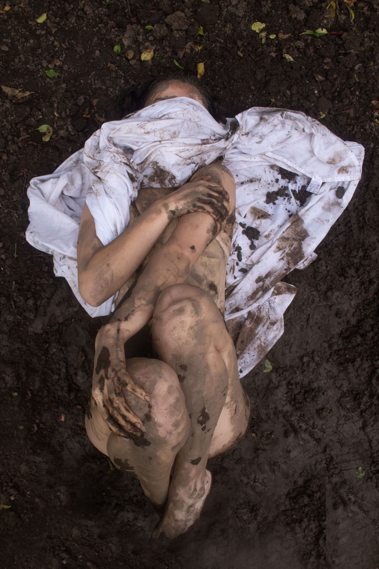 a woman covered in mud