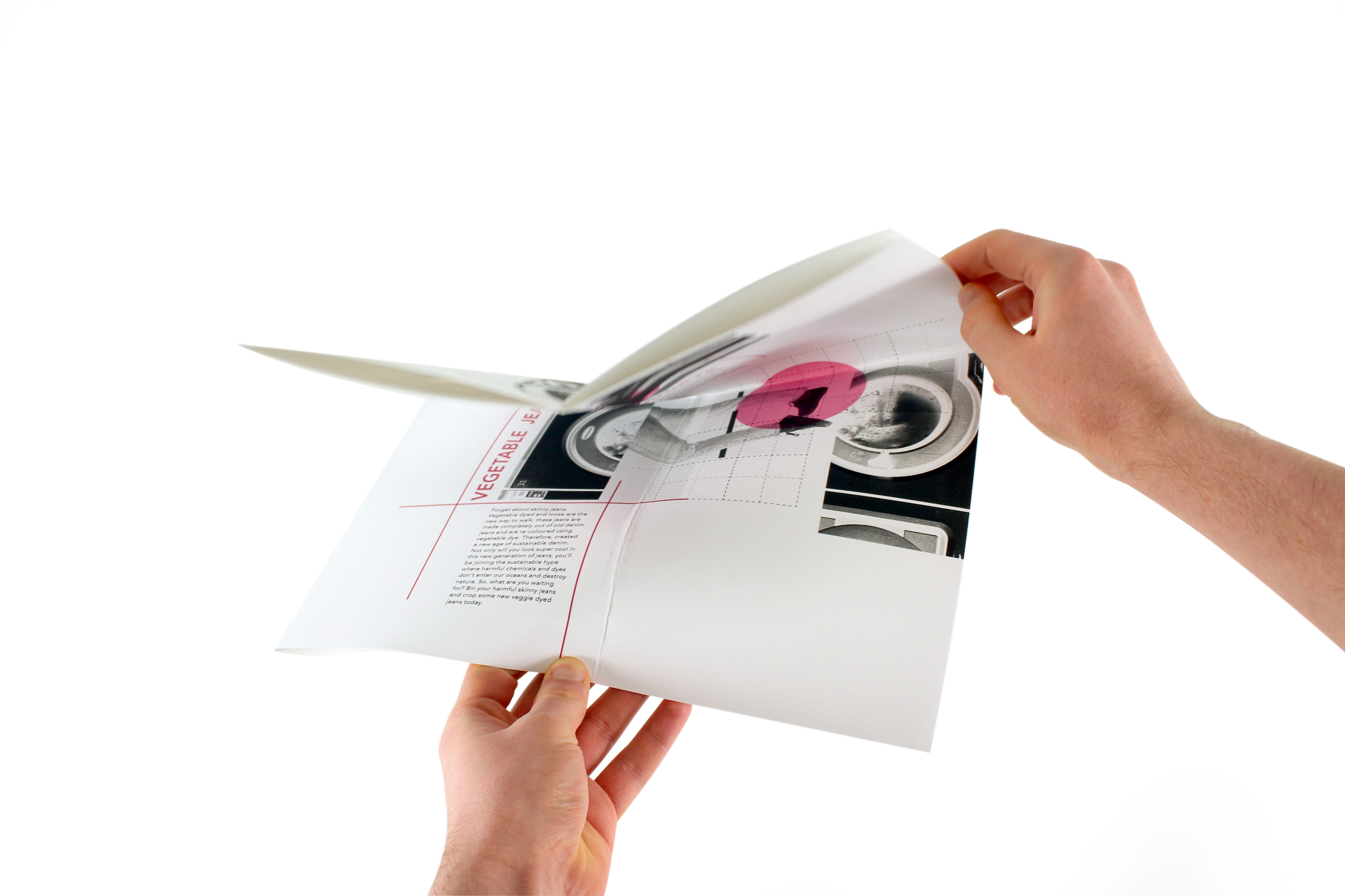 A folded, white booklet containing pink writing, and black and white photographs.