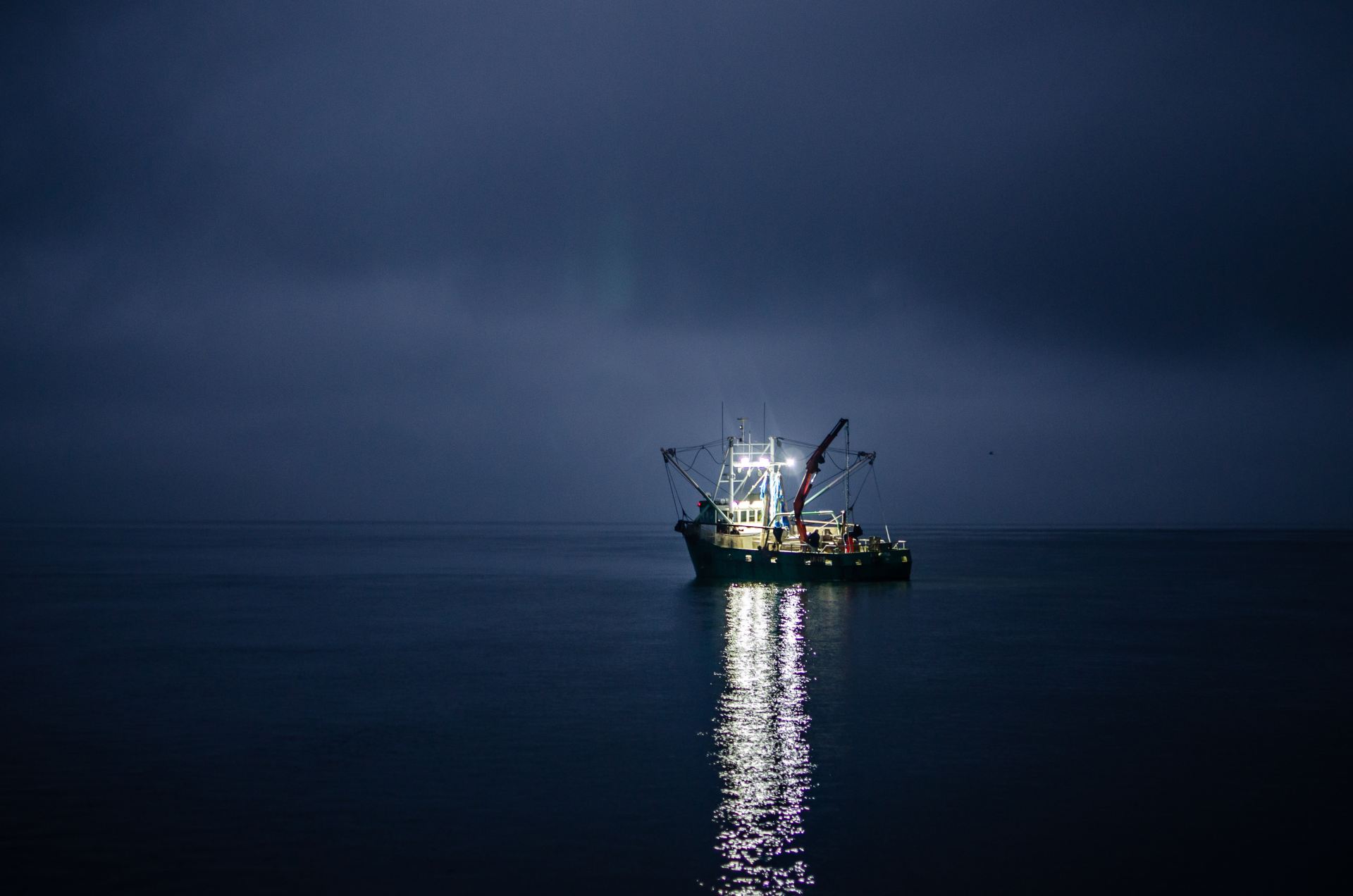 Trawler Fishing boat in the middle of the ocean at night