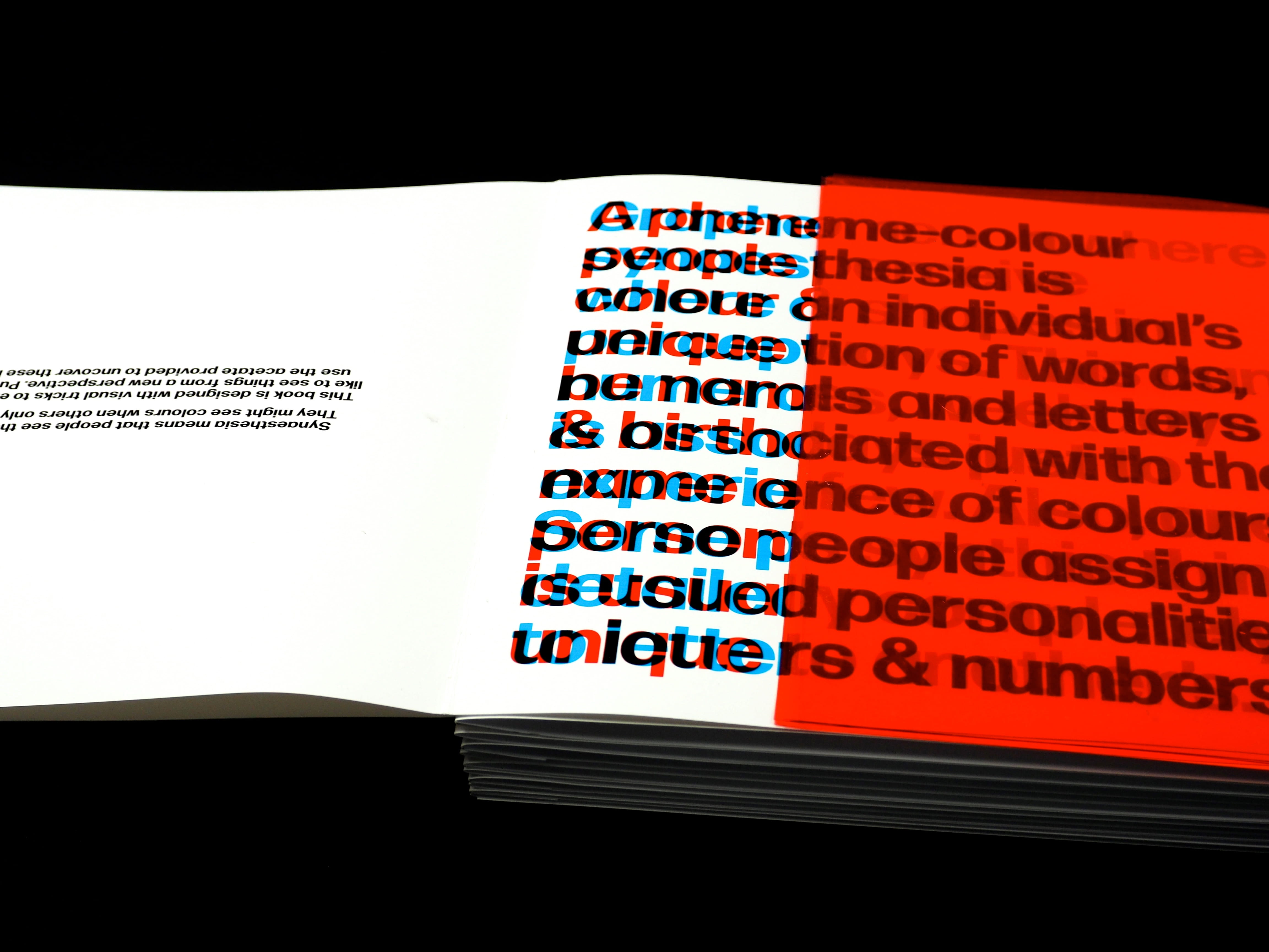 A body of jumbled text in black, red, and blue overlapping, half of the page is covered in a orange translucent sheet.