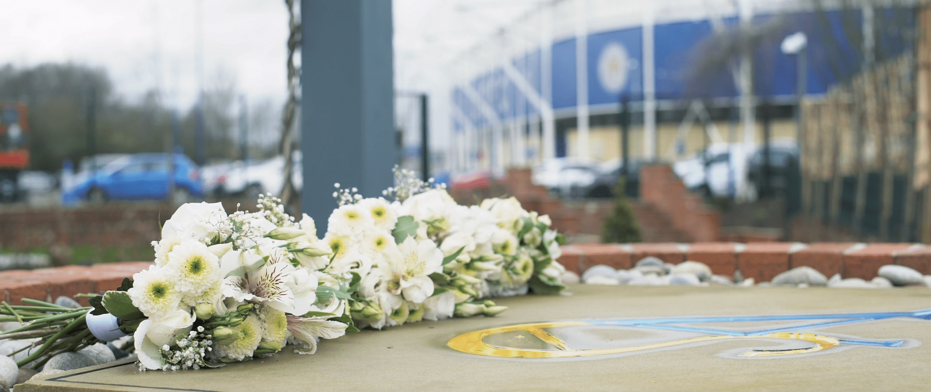 Flowers laid on the floor outside Leicester City Football Stadium. 