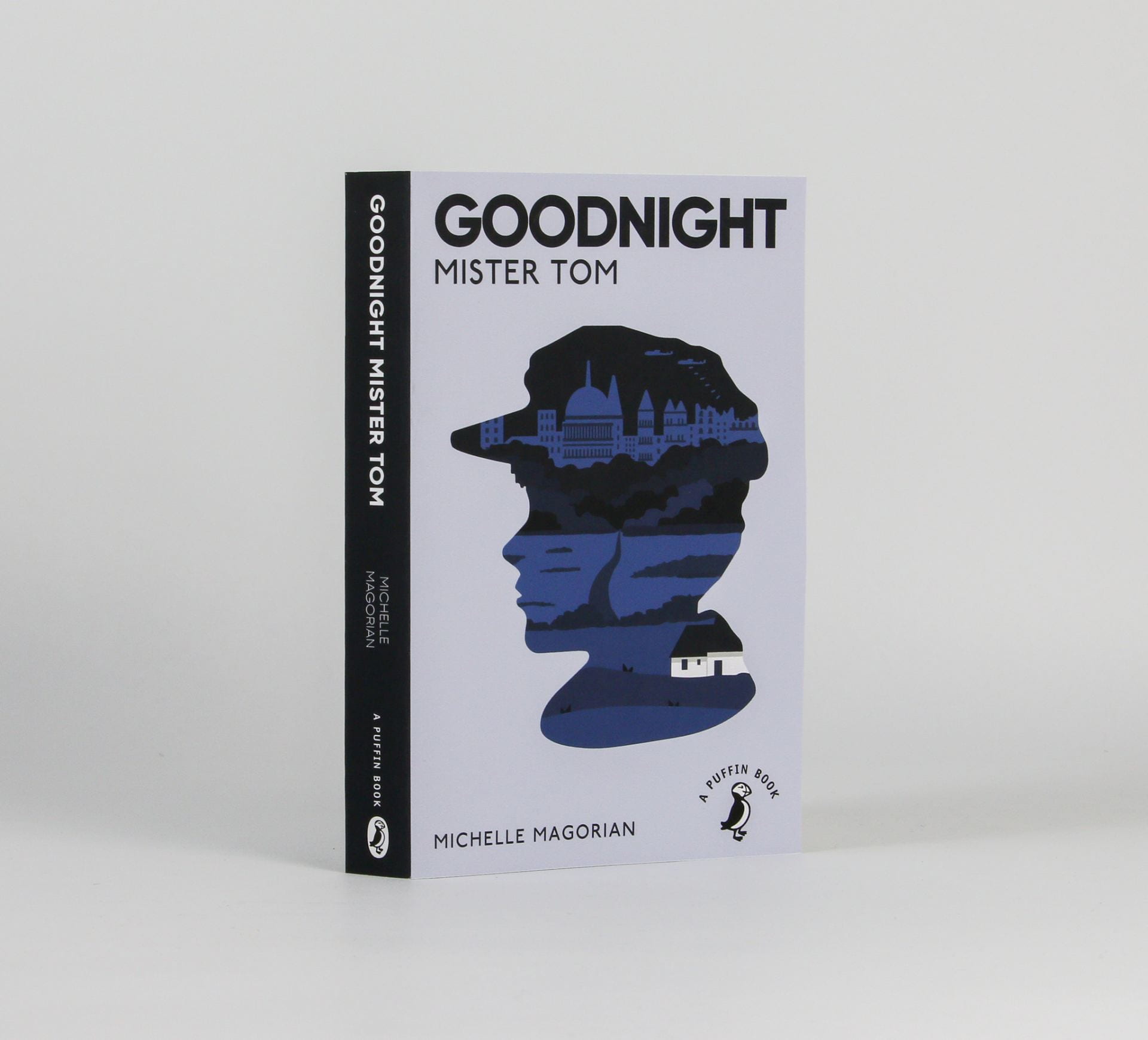 Book cover reading 'Goodnight mister tom' with a silhouette of a boys head with the city inside