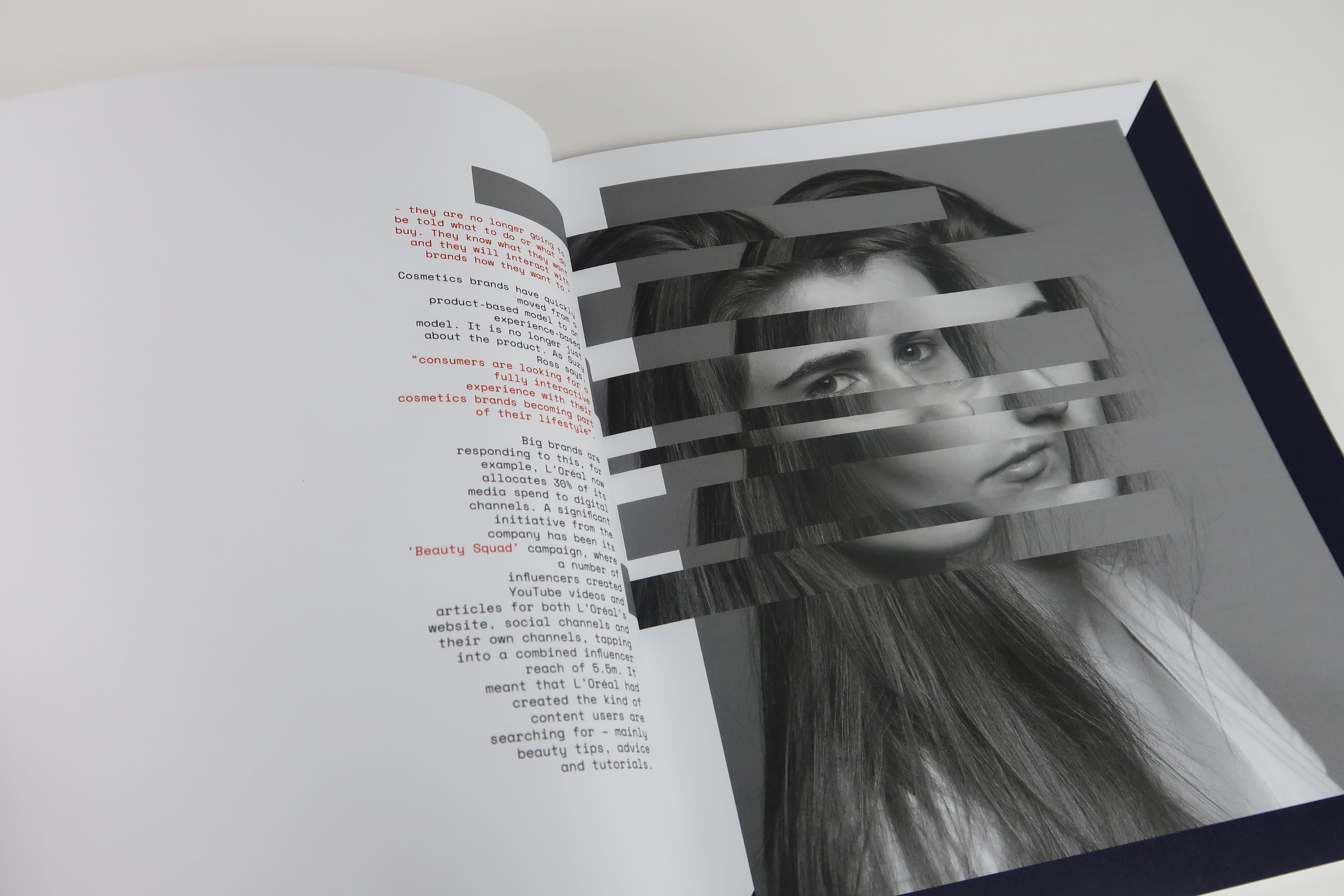 A double page magazine spread, a black and white portrait image with a glitch effect runs across the spread, accompanied by a body of text.