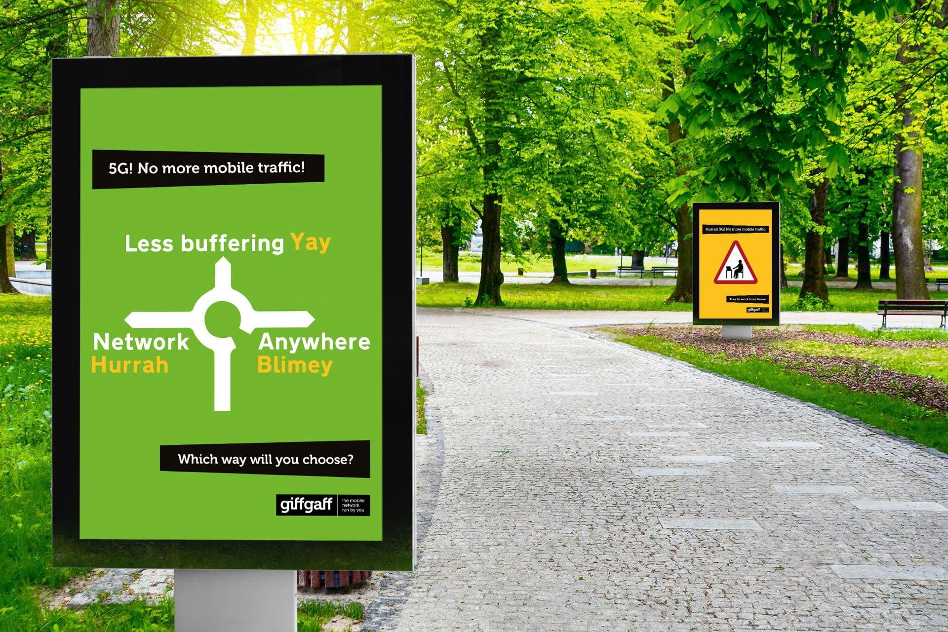 Photograph of a a sign in a park with posters for giffgaff.